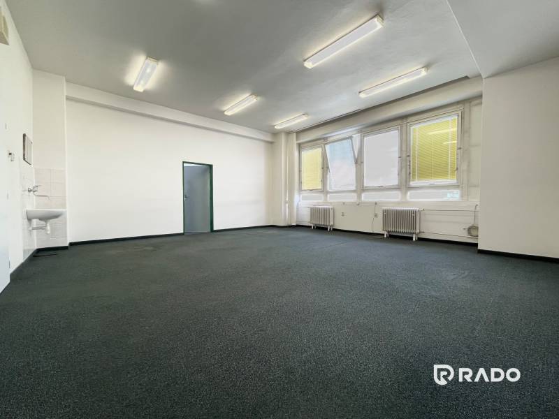 Offices with large windows and a sink, suitable for business.
