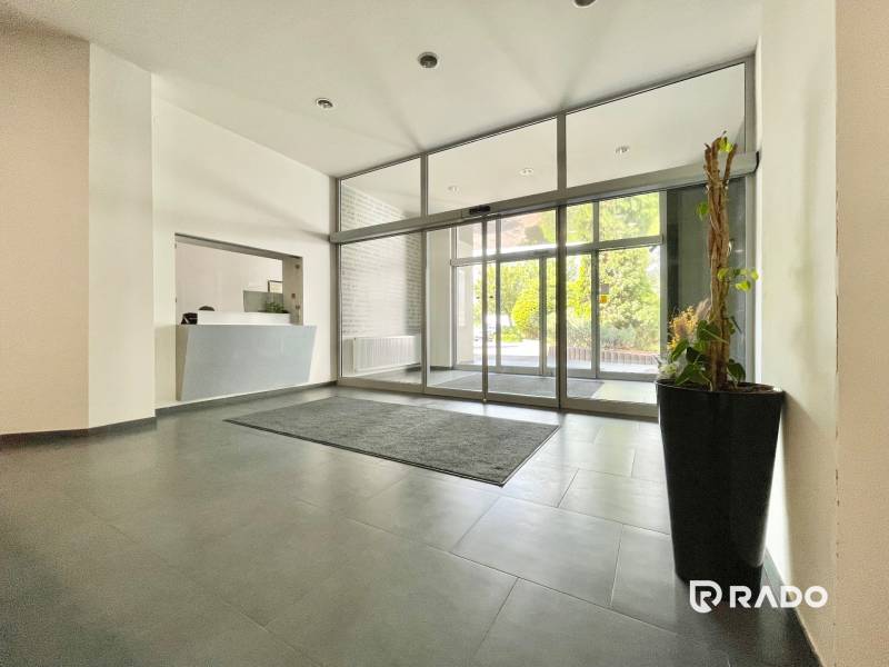 Lobby with reception and large glass doors, offices.