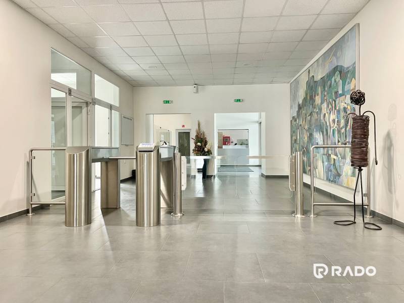 Lobby in offices with secured turnstiles.