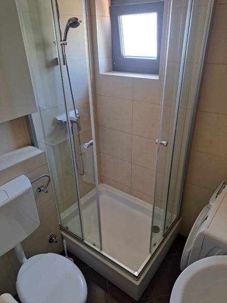 Bathroom with toilet and shower in a 3-room apartment.