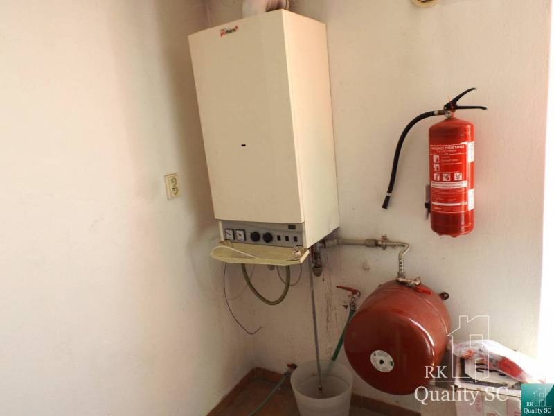 Heating in the building with a boiler and a fire extinguisher on the wall.