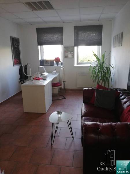 Office with a sofa and a desk, simple interior of a building.