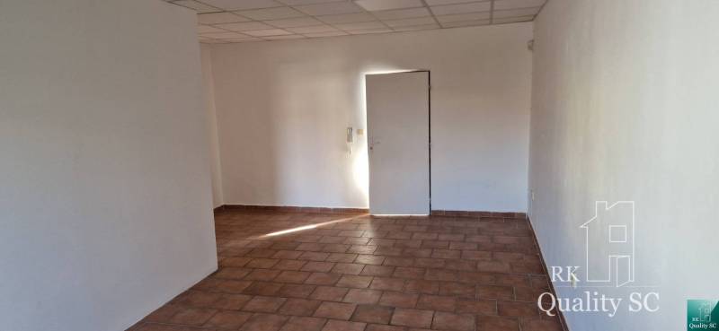 The interior of the building with white walls and tiled flooring.