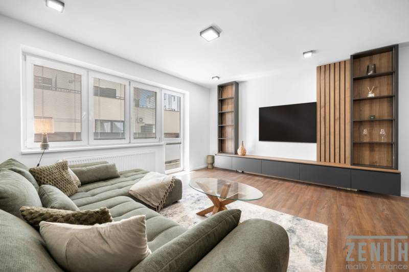 Living room in a 3-room apartment with a comfortable sofa and modern furniture.