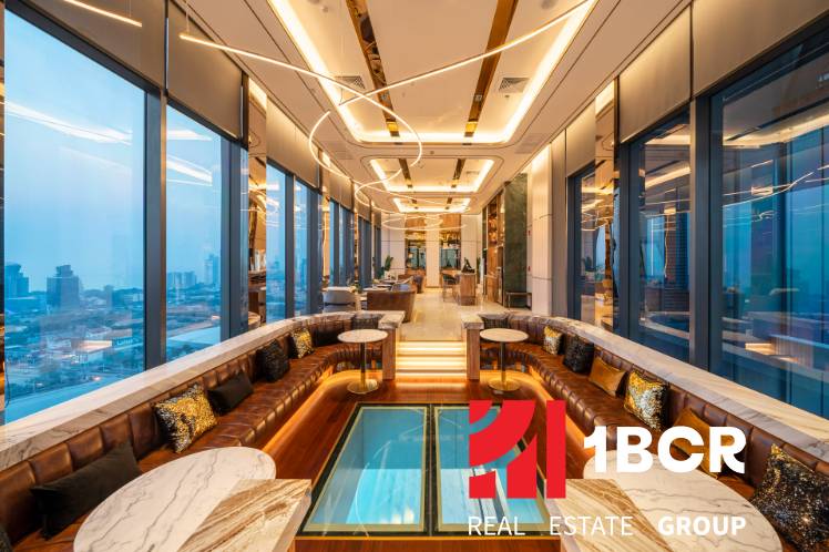 Luxurious interior with panoramic views, sofas, and marble tables within the apartment construction.