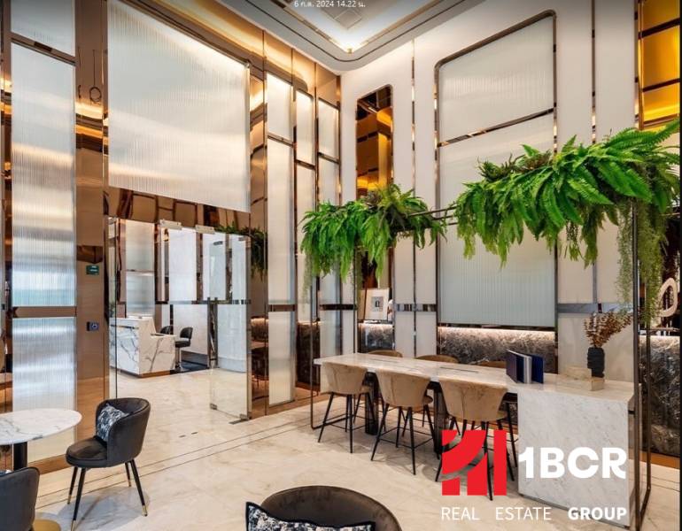 Luxurious interior with white marble furniture and green plants in apartment construction.