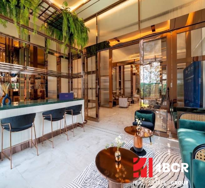 Interior of a luxurious living room with a bar counter and designer furniture. Apartment construction.