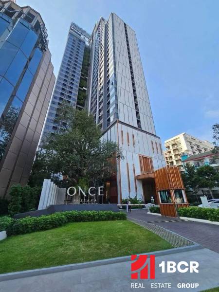 Apartment construction in Pattaya with high-rise buildings and landscaped green surroundings.