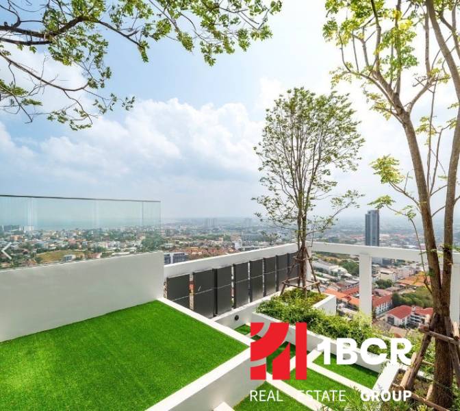 Rooftop terrace with a view of the city of Pattaya and residential buildings.