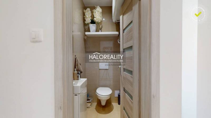 A small bathroom with a toilet and a sink in a 3-room apartment.