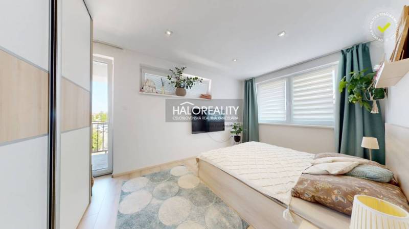 A bright bedroom with a large bed and balcony doors in a 3-room apartment.