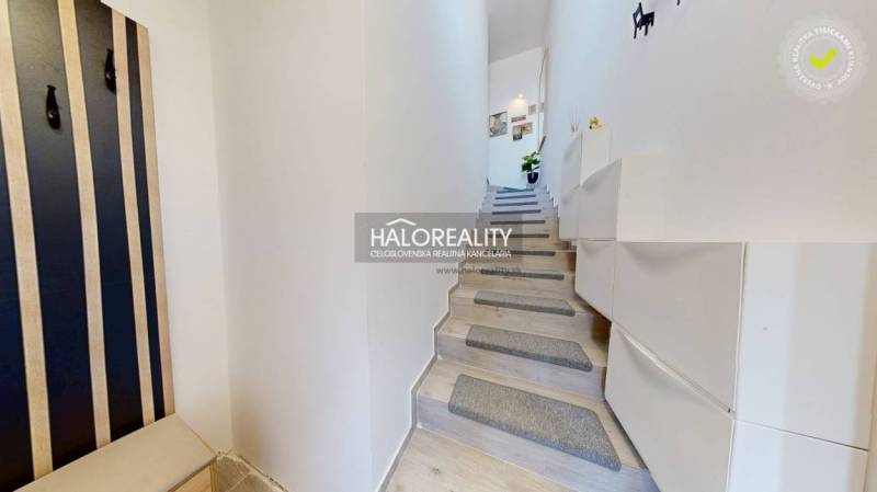 Interior of a 3-room apartment with a modern staircase and storage space.