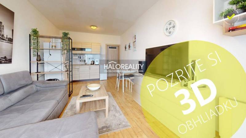 A studio apartment with an open kitchen, sofa, and modern furnishings, suitable for living.