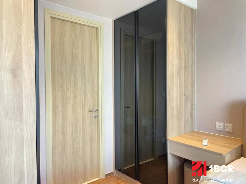 Wooden door and glass cabinet in the bedroom of a 2-room apartment.