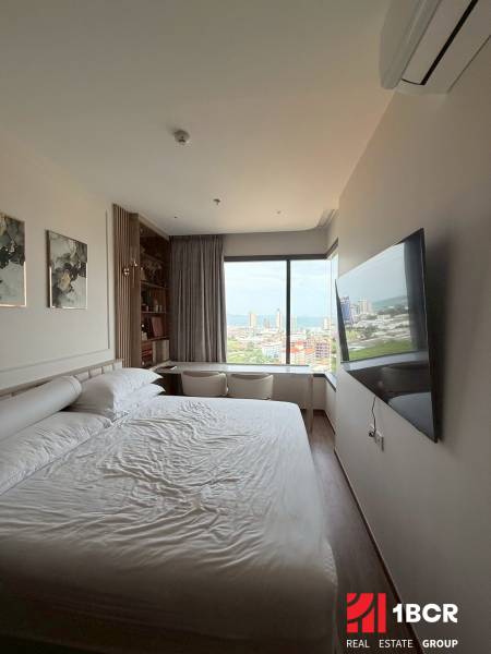 Bright bedroom in a 3-room apartment with a view, bed, and wall-mounted television.