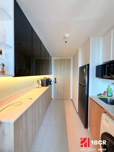A kitchen in a 3-room apartment with modern equipment and a light floor.