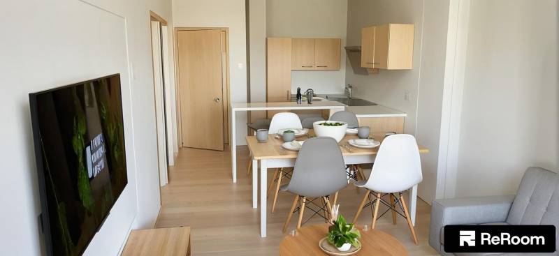 Kitchen and dining area in a 3-room apartment with wooden furniture.