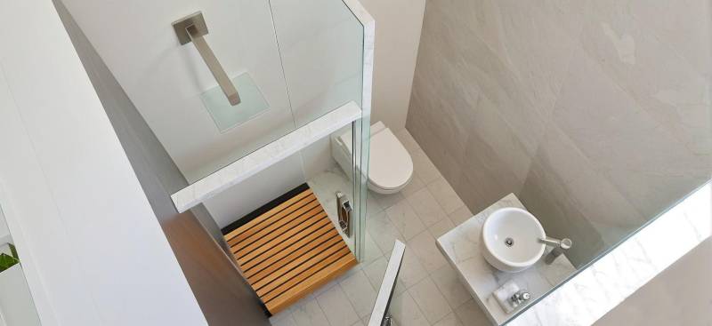 Bathroom in a 3-room apartment with a toilet, shower, and sink.