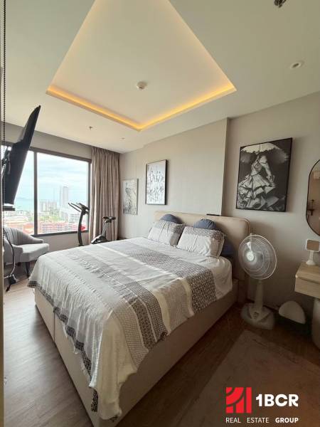 A bright bedroom with a large bed and a view in a 3-room apartment.