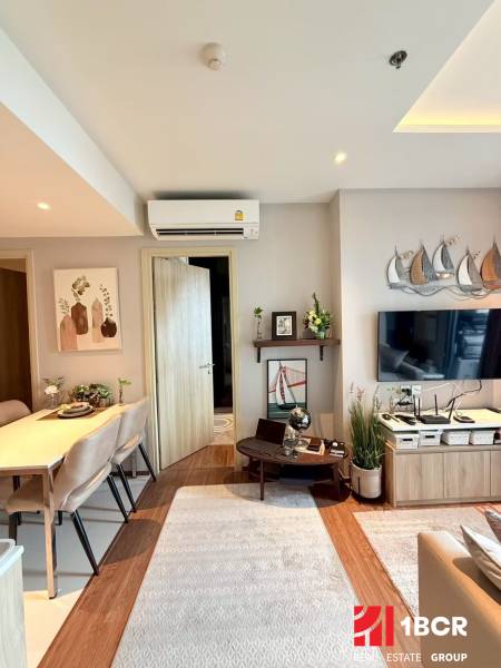 Living room of a 3-room apartment furnished with a table, chairs, and wall decorations.