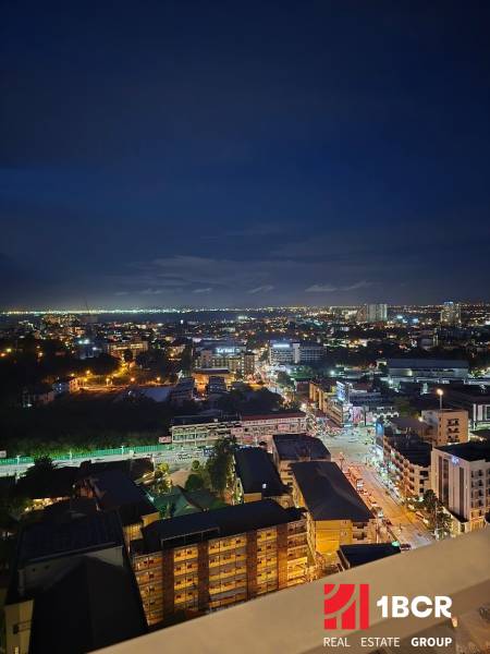 Night panorama of Pattaya, view from a studio apartment of the illuminated city.
