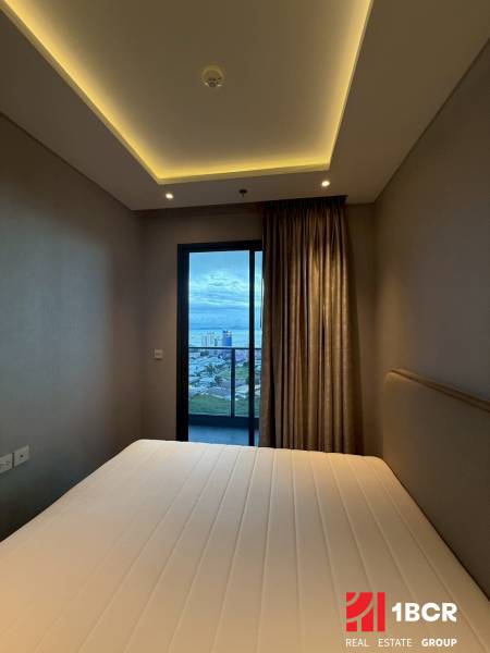 Bedroom with built-in lighting and a view of the balcony, 3-room apartment.