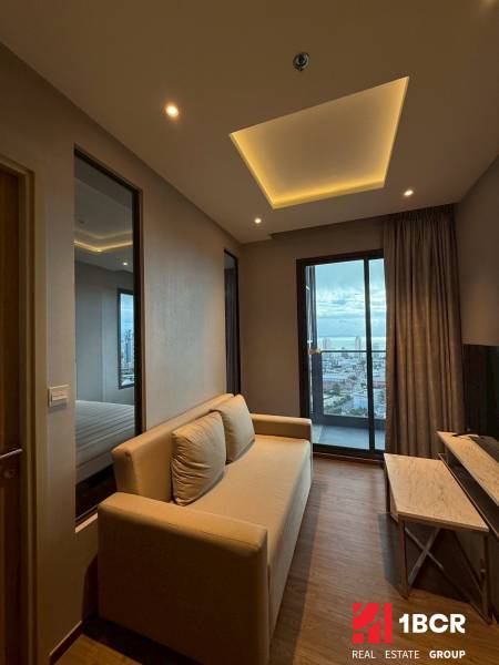 Living room in a 3-room apartment with a sofa, television, and a view of the city.