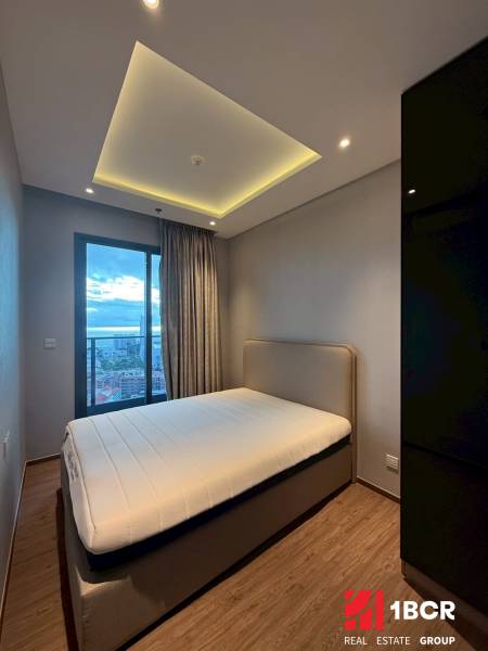 Bedroom in a 3-room apartment with a bed, built-in wardrobe, and curtains by the window.