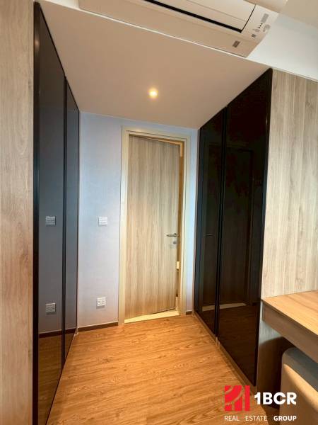 A hallway in a 3-room apartment with wardrobes, wooden details, and flooring.