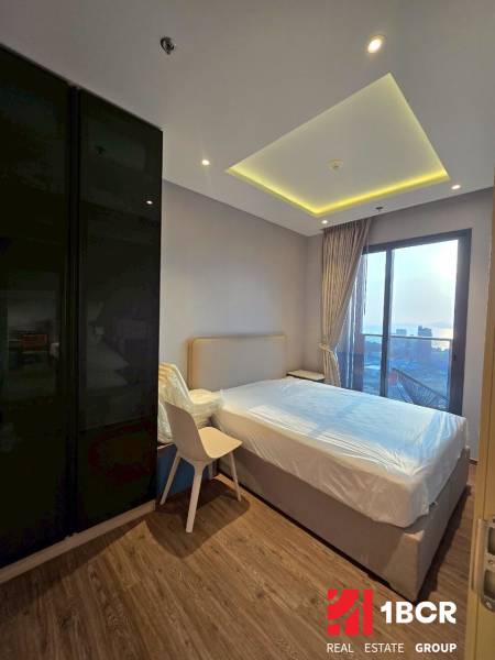 Bedroom in a 3-room apartment with a large window and wooden floor.