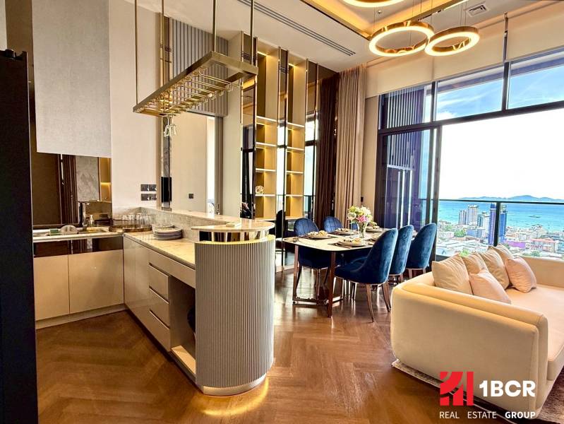 Luxury kitchen and living room with a view of the coastline in a 4-room apartment.