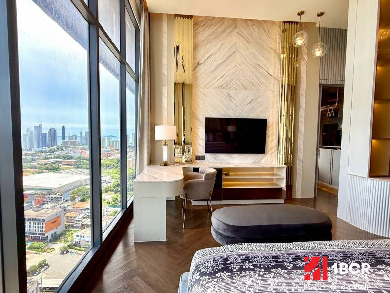 A stylish 4-room apartment interior with a view of the city skyline, elegant furnishings.