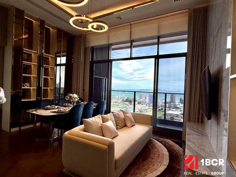 Living room in a 4-room apartment with a view of the city and the sea.