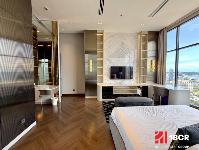 Luxury bedroom with a view, wooden floor, television, and desk in a 4-room apartment.