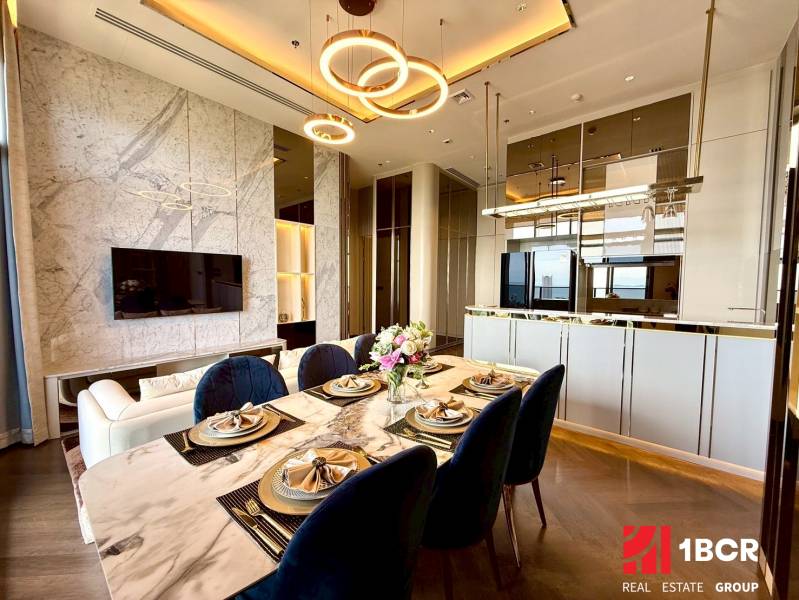 Dining table and living room in a 4-room apartment with a modern interior.