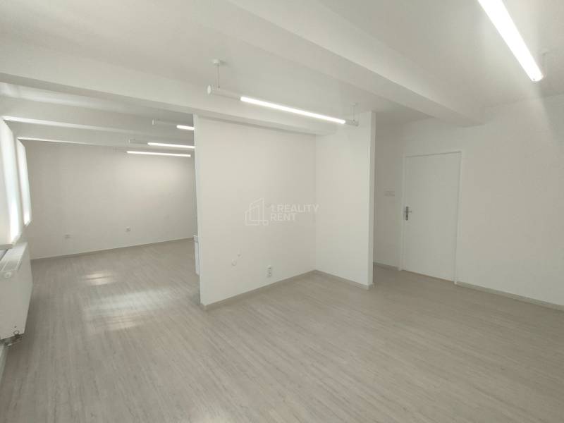 A bright interior with white walls and flooring in commercial spaces.