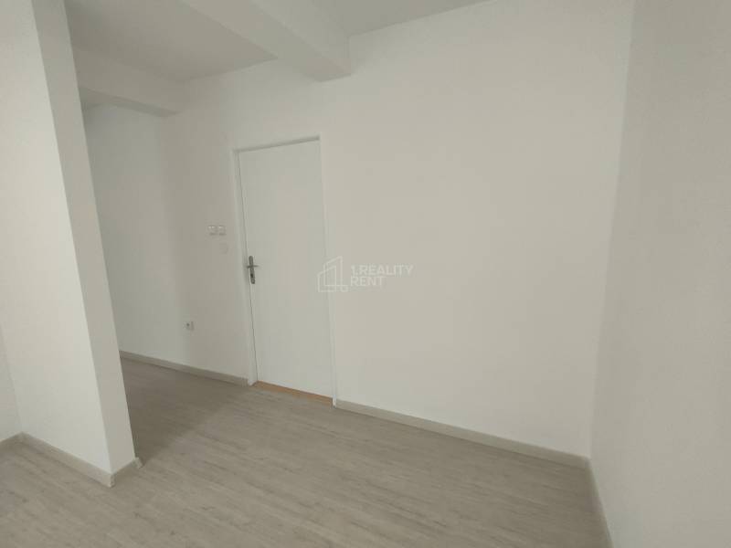 Commercial premises with white walls and wooden flooring.
