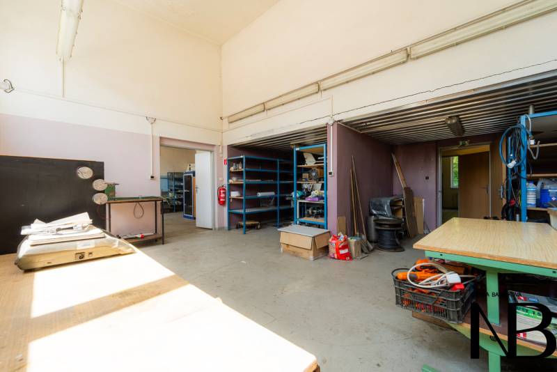 Interior of warehouses and halls with shelves and workbenches, equipped with various tools and materials.