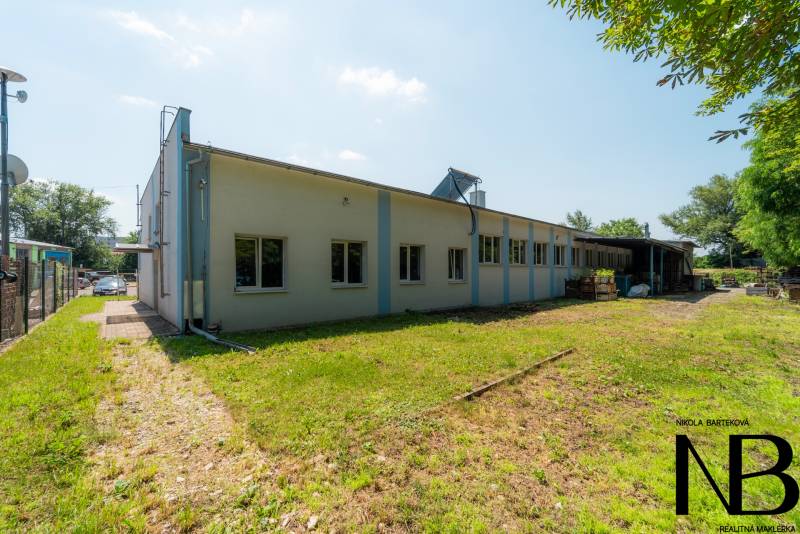 Warehouse and hall building on Kasárenská Street in Trenčín with surroundings and greenery.