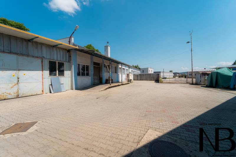 Industrial area on Kasárenská in Trenčín with warehouse and hall buildings.