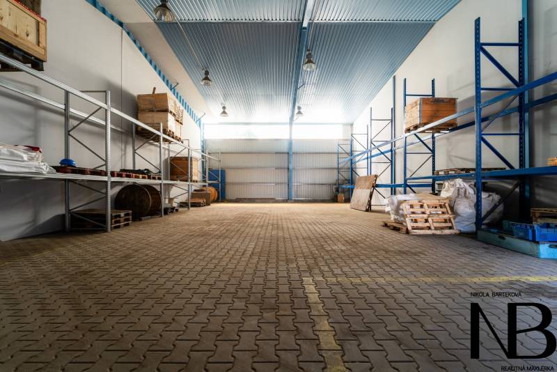 Warehouses and halls with shelves and pallets for material storage.