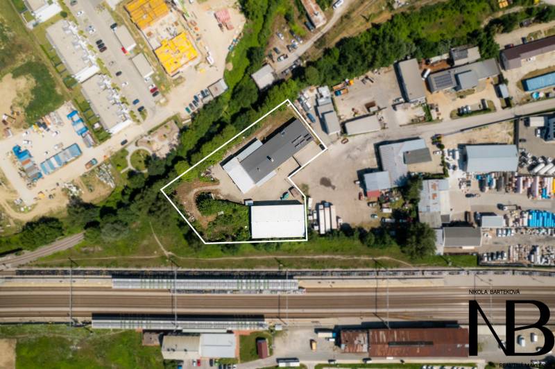Aerial view of warehouses and halls in Trenčín on Kasárenská Street near the railway track.