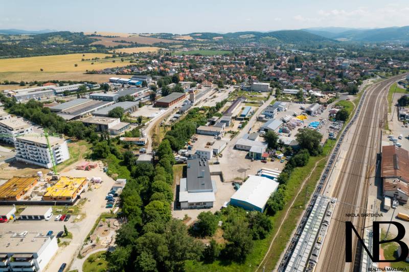 Aerial view of the industrial area on Kasárenská Street in Trenčín with warehouses and halls.