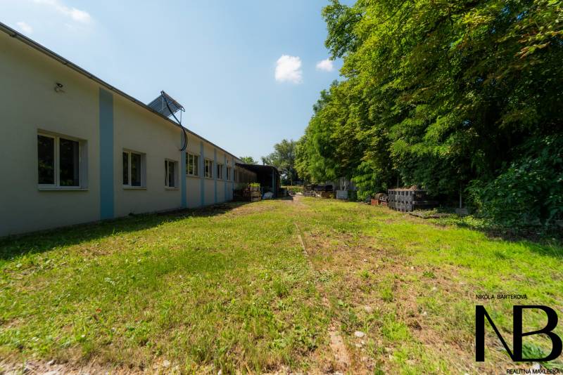 Production premises on Kasárenská Street in Trenčín surrounded by greenery and open space.