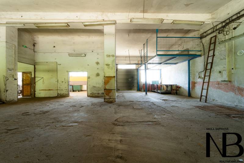 Abandoned industrial spaces with old metal stairs and worn-out flooring.