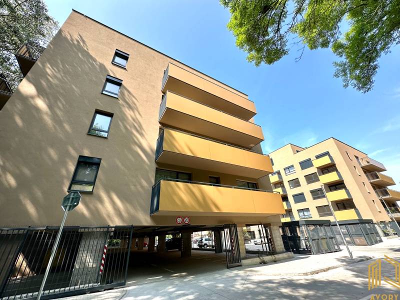 Apartment complex with glass balconies, garages in Senica on Sadová Street.