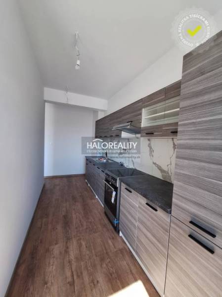 Kitchen in a 2-room apartment with a light floor design and modern equipment.