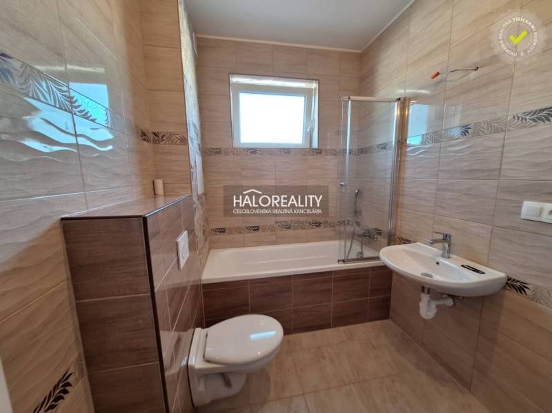 Bathroom in a 2-room apartment with a bathtub, sink, and toilet.