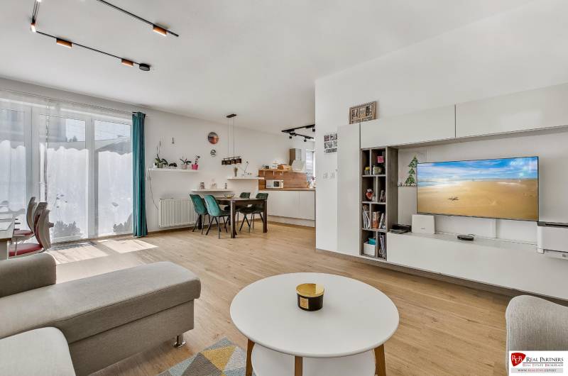 Living room with kitchen in a family house, bright, spacious, with comfortable furniture and a television.