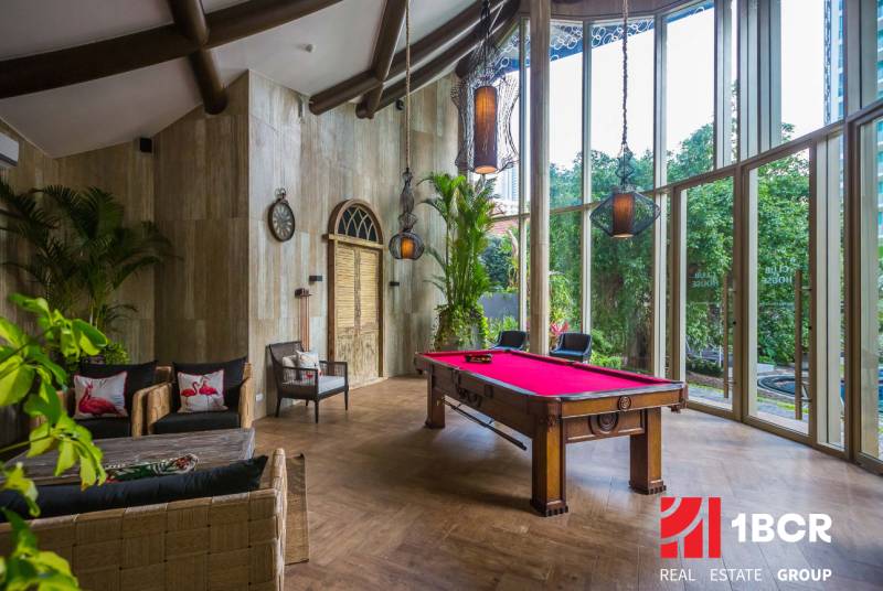 Interior with a billiard table, comfortable seating, and large windows, Apartment construction.